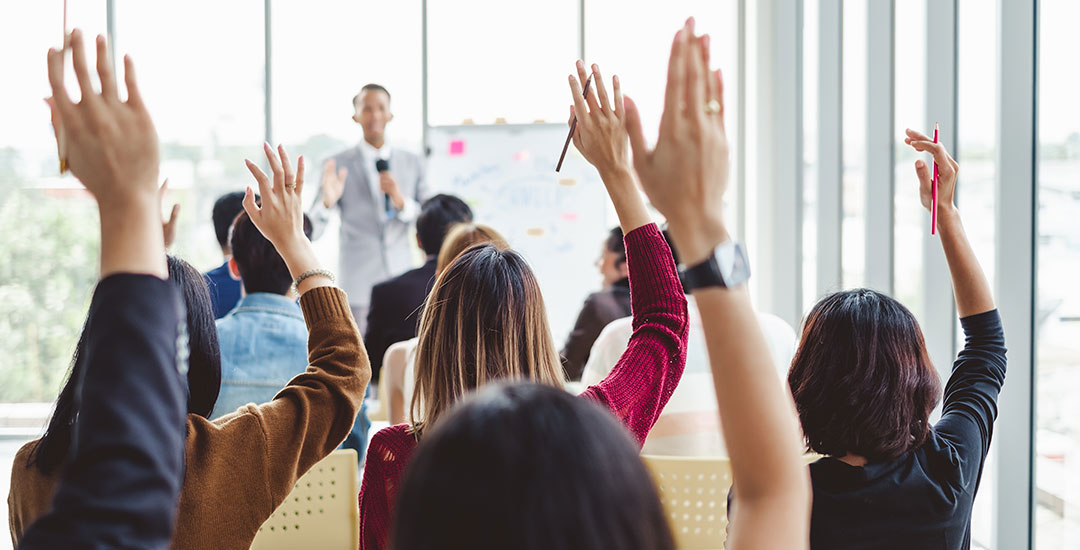 Teacher with Student with Hands Raised